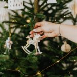 person holding rocking horse christmas ornament